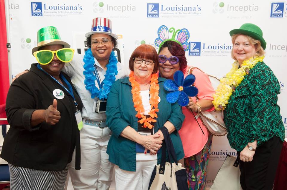 LCTCS employees posing at a photo booth